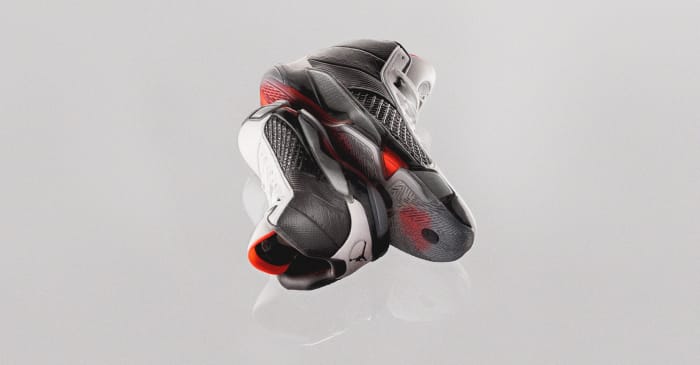 View of stacked black and red Air Jordan basketball shoes.